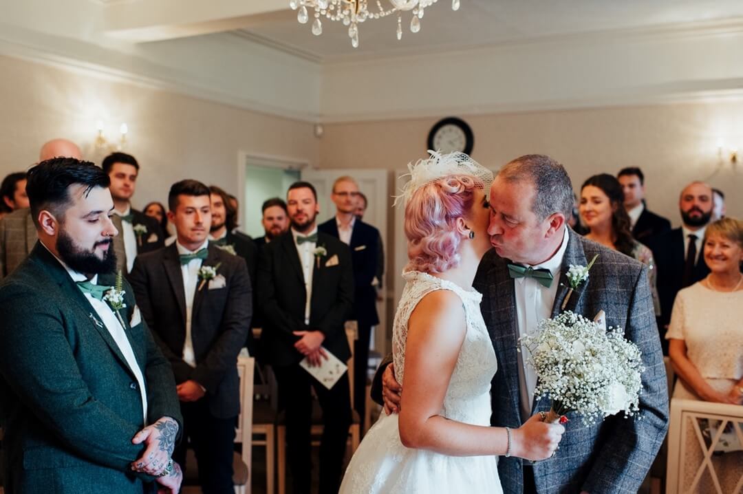 alternative bride kisses dad in ceremony