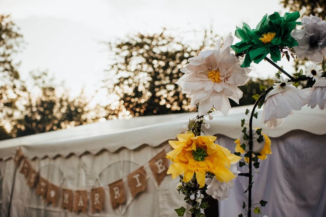 paper flowers decorating wedding marquee
