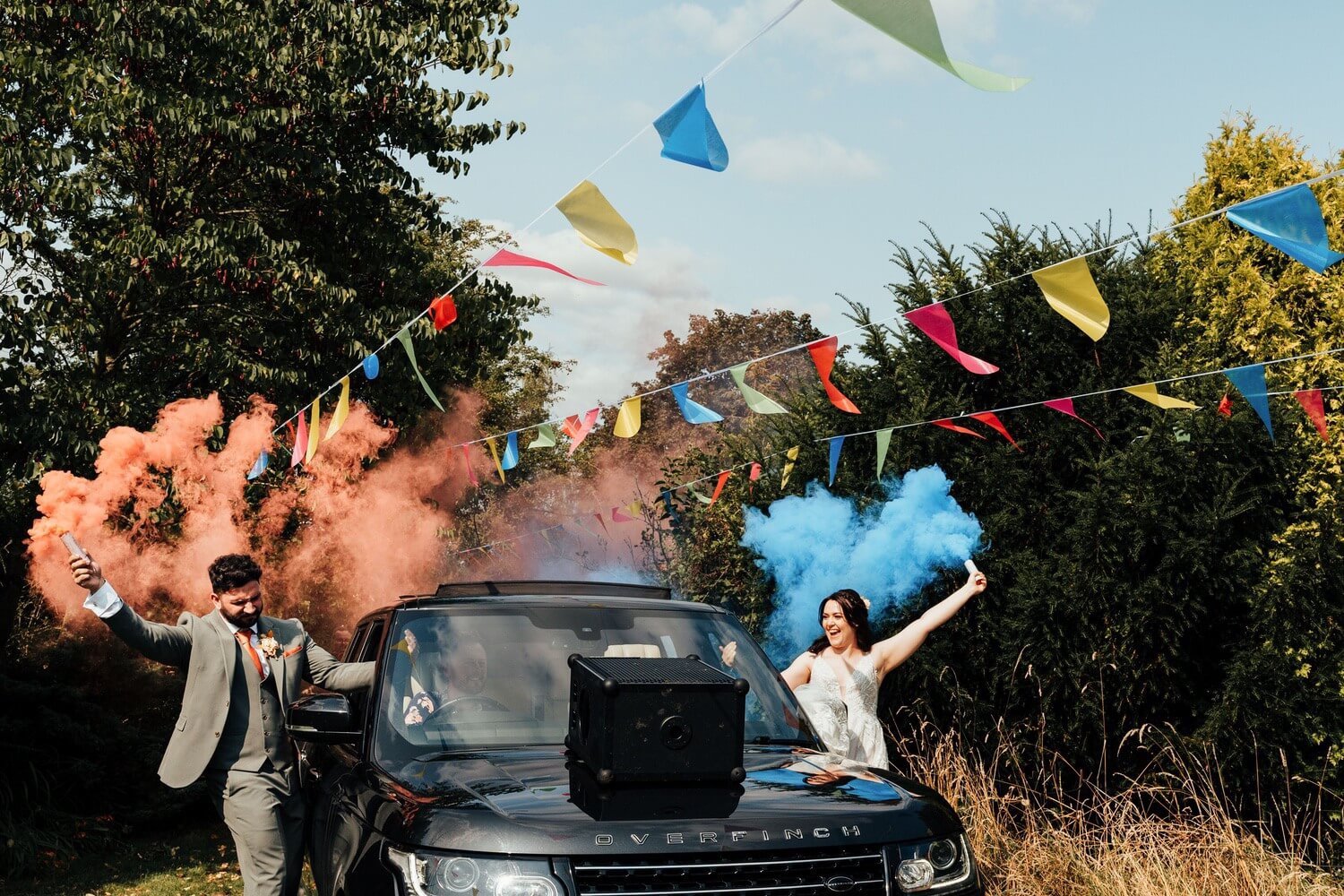 Molecey Mill Wedding photographer, a photo of bride and groom with smoke bombs