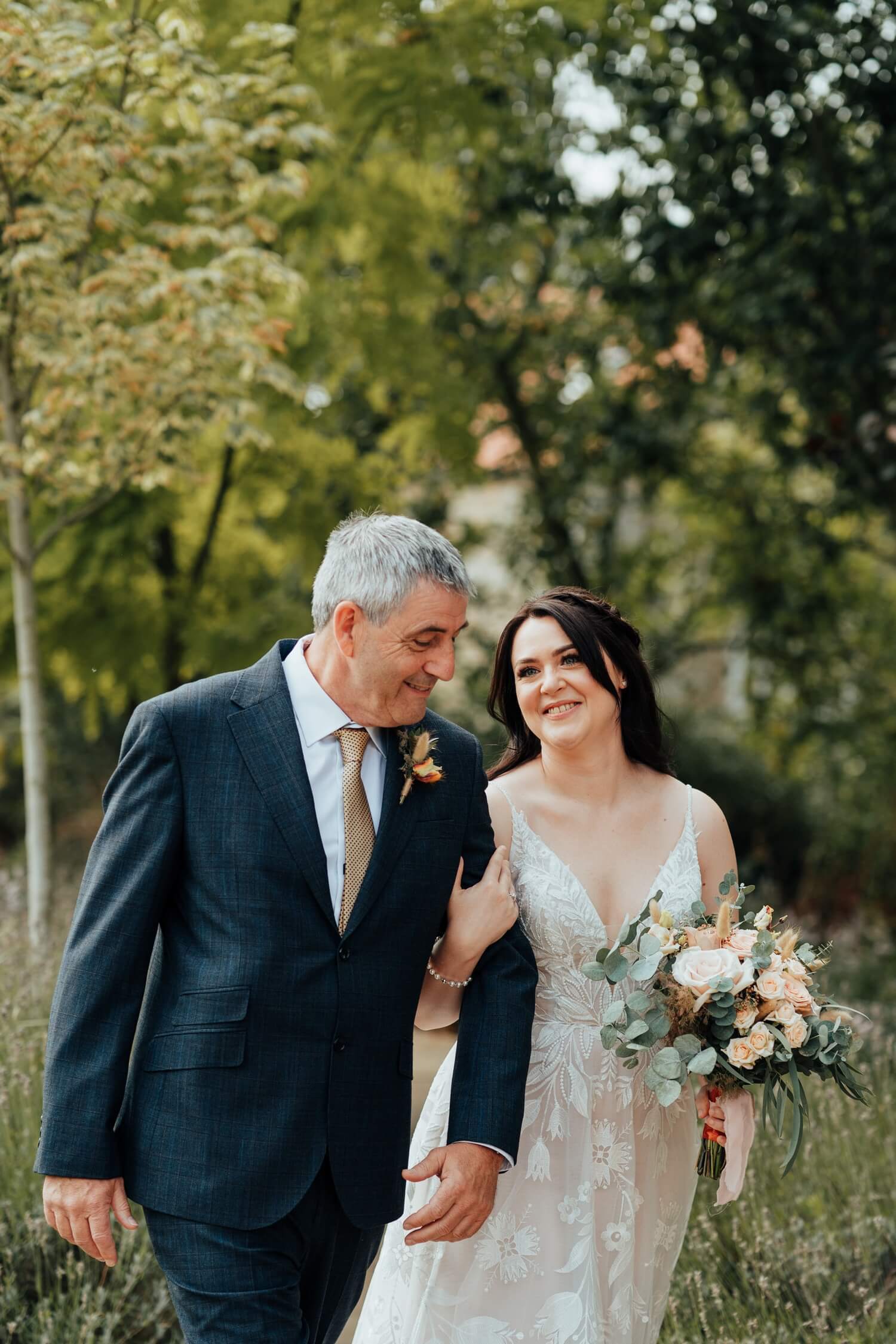 Bride walking with Dad on way to Molecey Mill Wedding ceremony