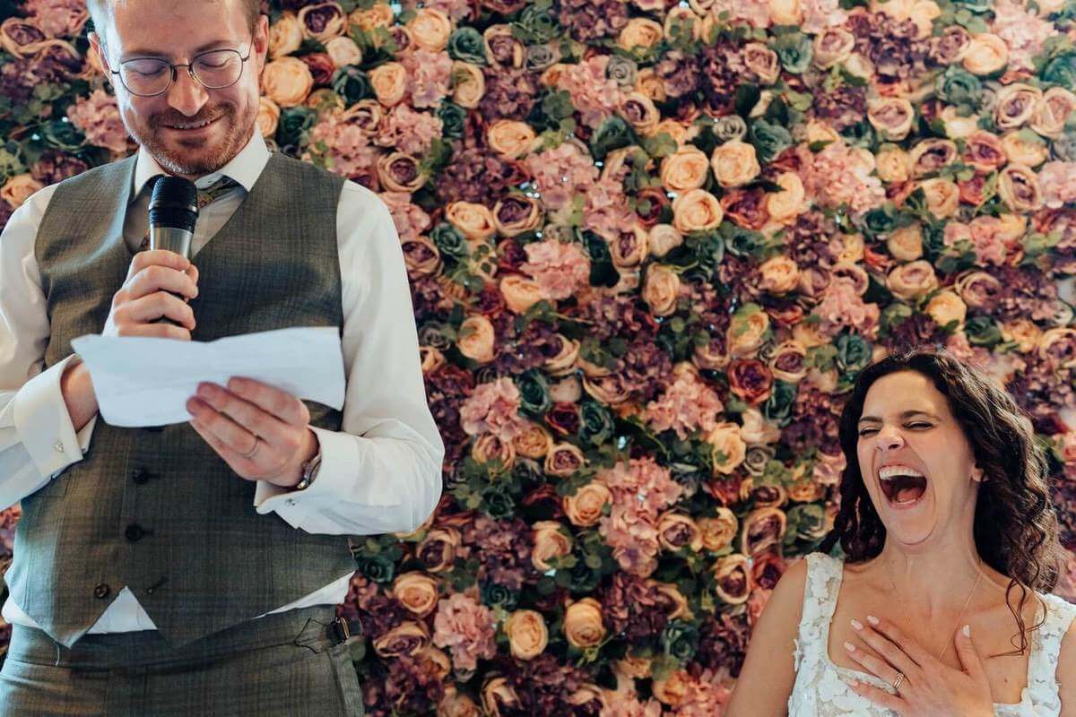 Bride and groom laughing during wedding speeches photographed by Leicestershire wedding photographer Nathan Walker