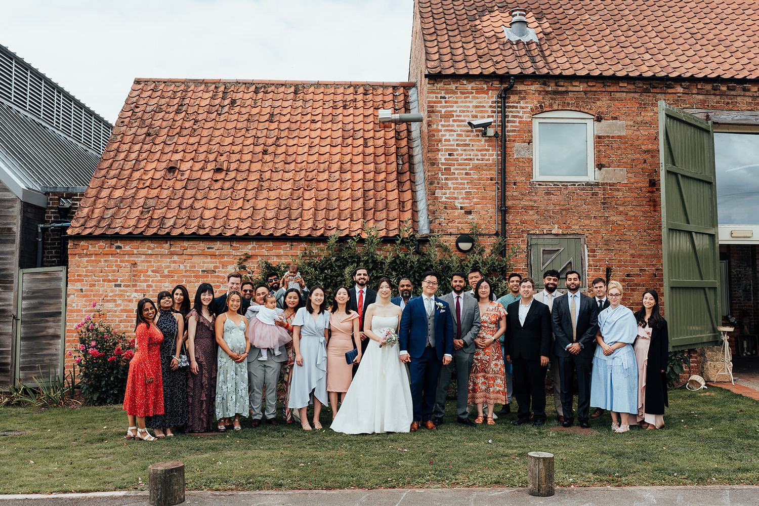 A family wedding photo taken outside of Pheasantry Brewery