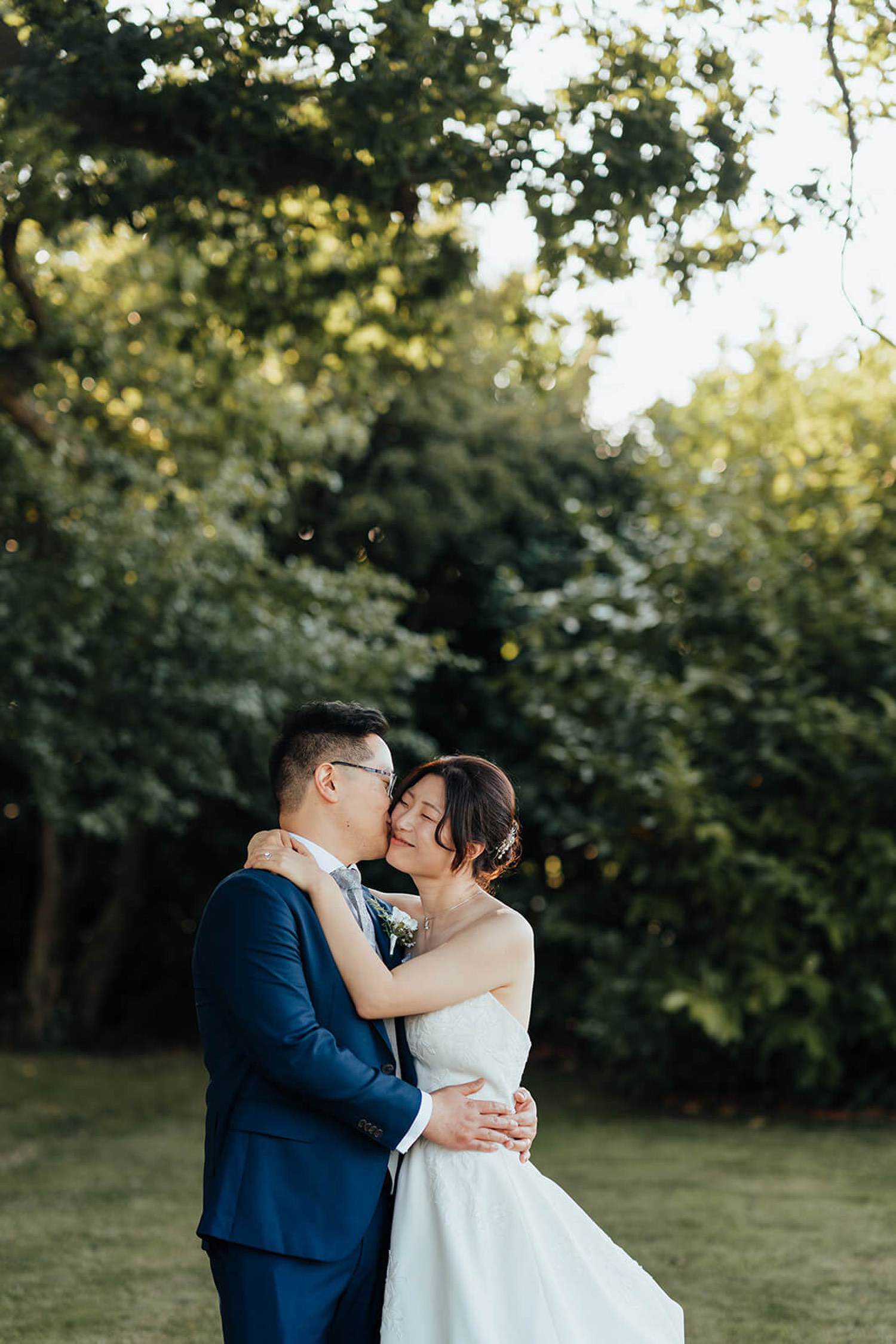 Bride and groom having their photo taken in the grounds of Pheasantry Brewery