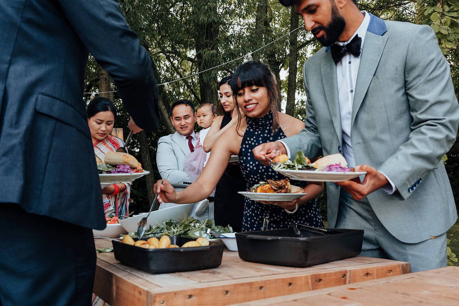 Guests eating food outside at Pheasantry Brewery wedding